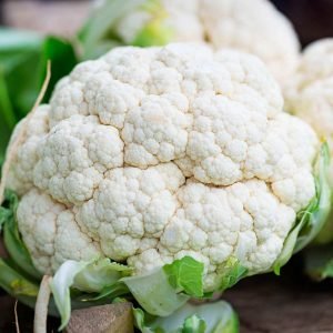 A close-up of a perfect, single head of cauliflower.